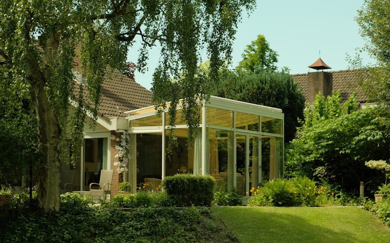 Modern glass sunroom addition on residential home