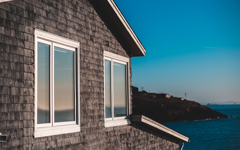 Home exterior with brick facade and large replacement windows